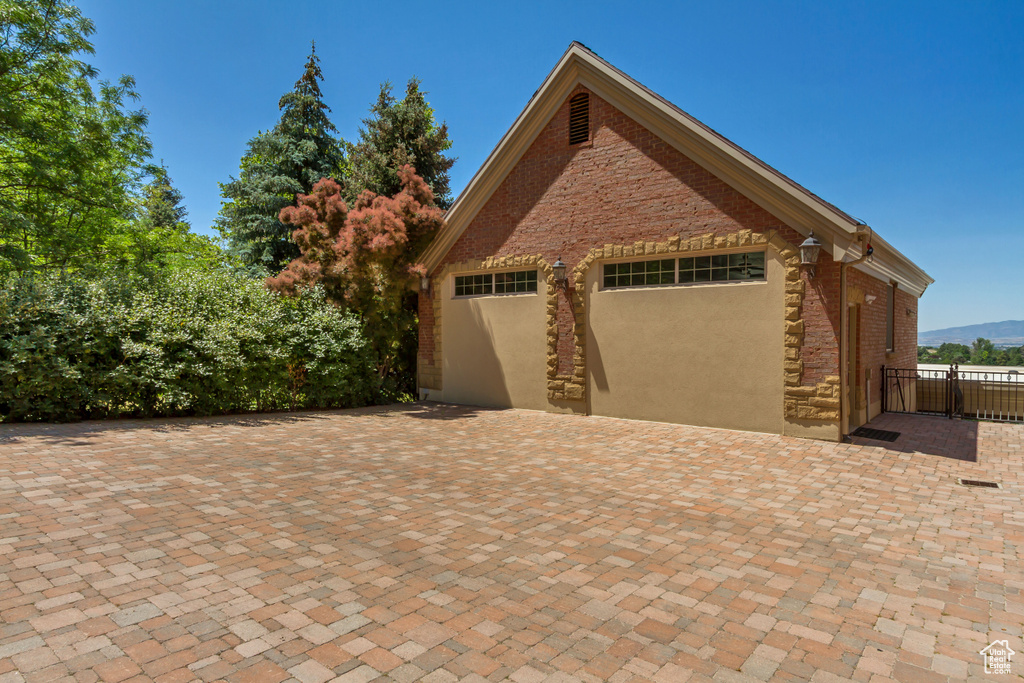 Garage featuring decorative driveway