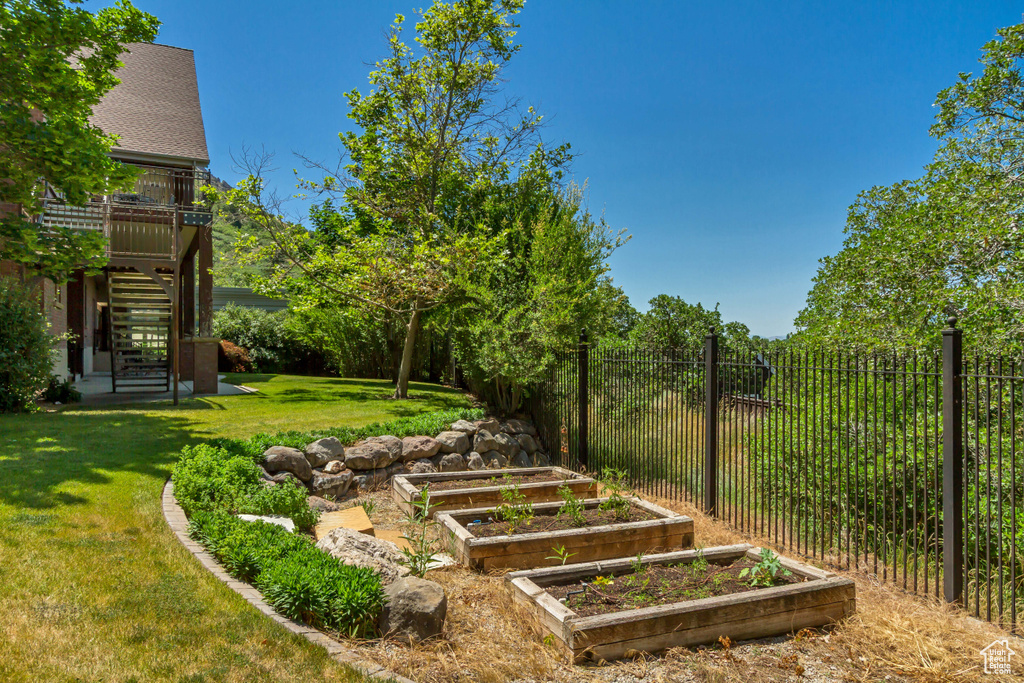 View of yard with stairs and a garden