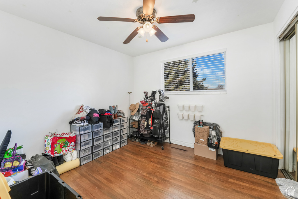 Interior space with a ceiling fan and wood finished floors