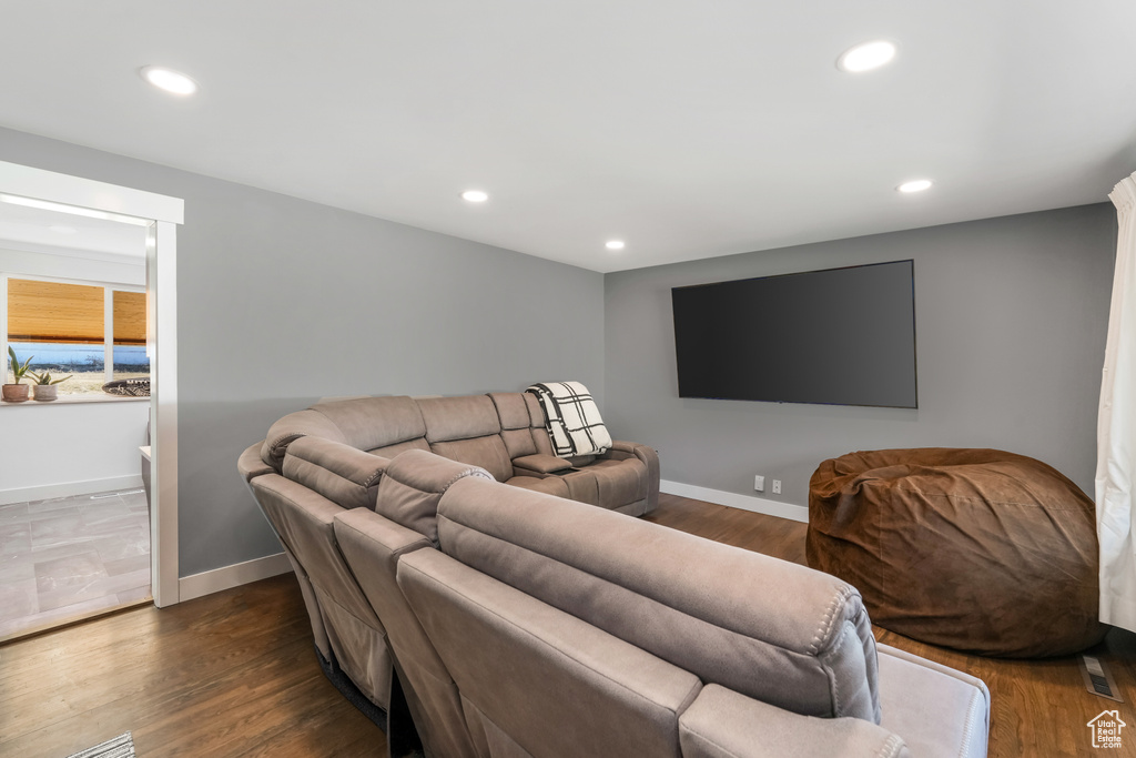 Living area featuring recessed lighting, baseboards, and dark wood-type flooring