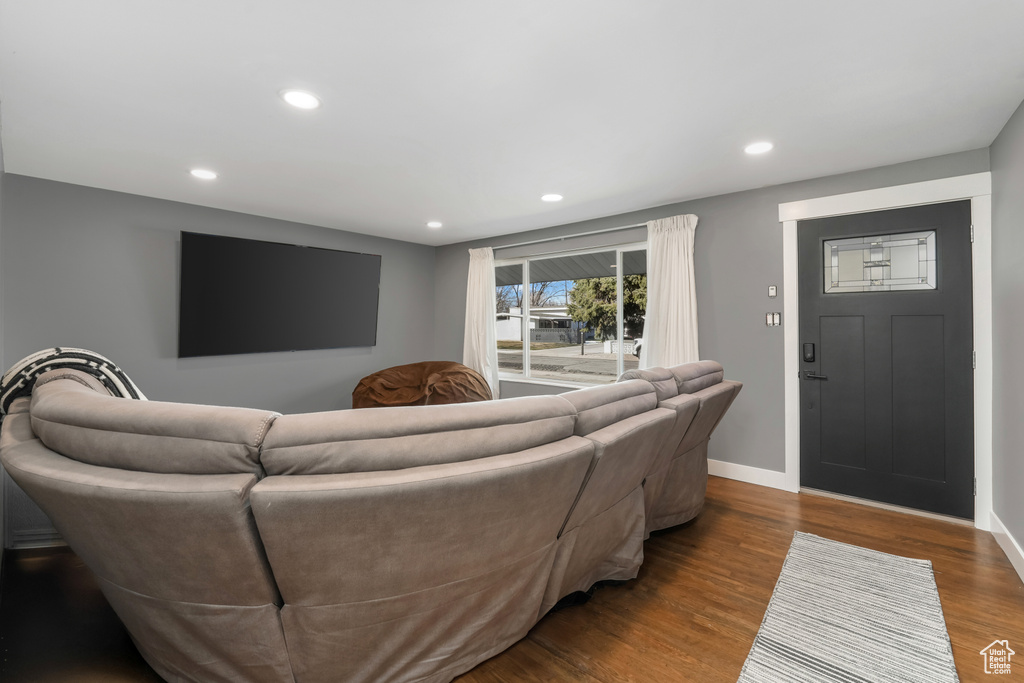 Living room with recessed lighting, baseboards, and dark wood-style floors