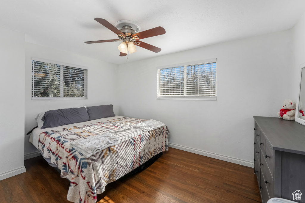 Bedroom featuring wood finished floors, baseboards, and ceiling fan