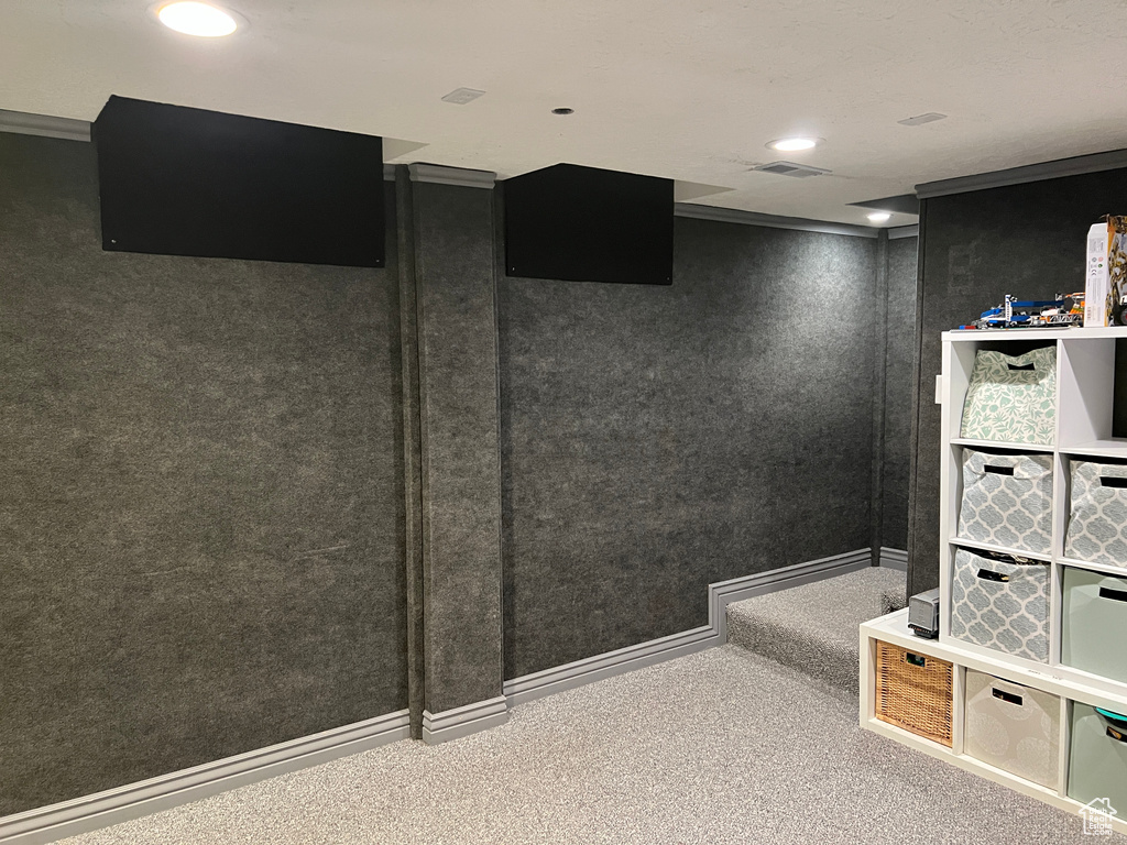 Interior space featuring recessed lighting, visible vents, baseboards, and carpet flooring