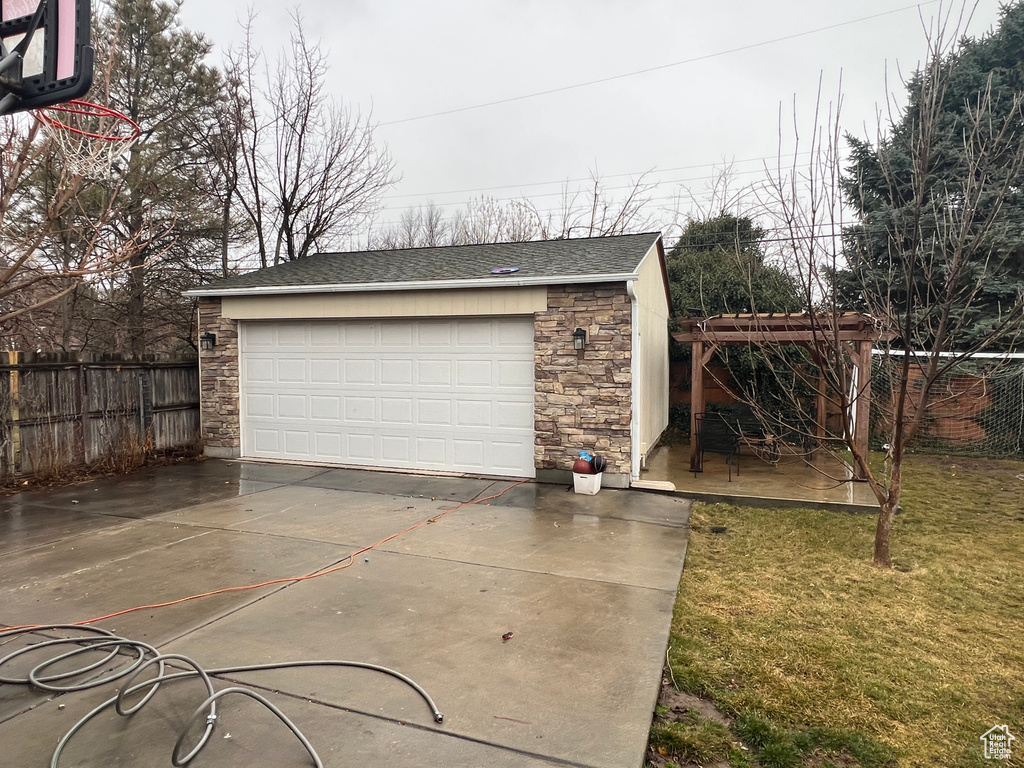 Detached garage featuring fence