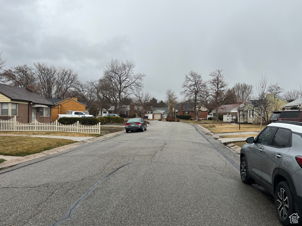 View of street featuring a residential view, curbs, and sidewalks