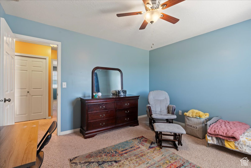 Carpeted bedroom featuring a ceiling fan and baseboards