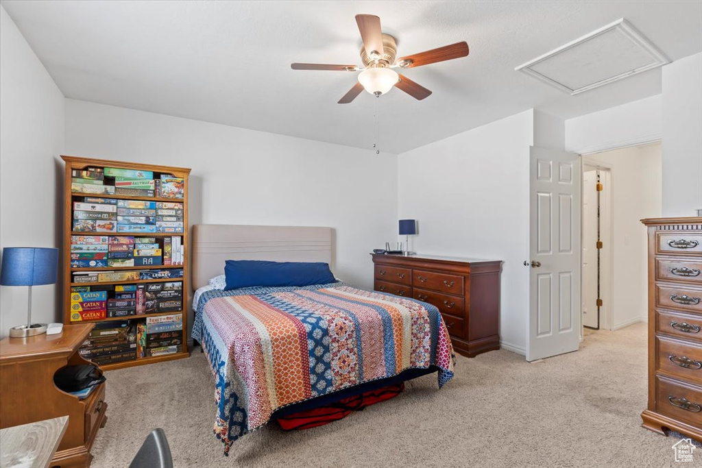 Bedroom featuring carpet floors, attic access, and ceiling fan