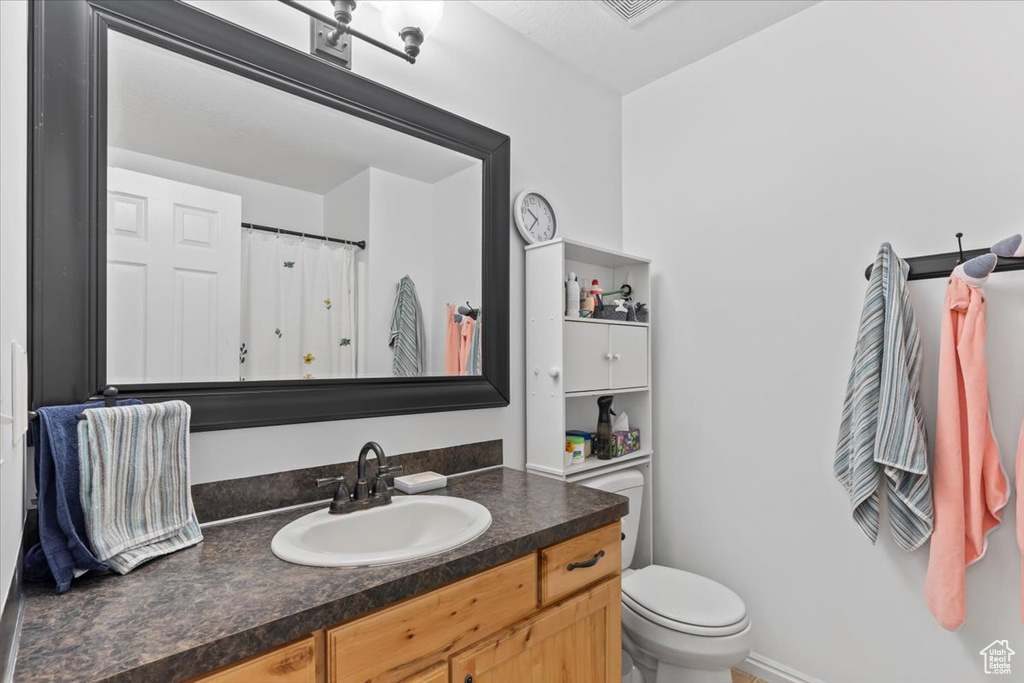 Full bathroom featuring vanity and toilet