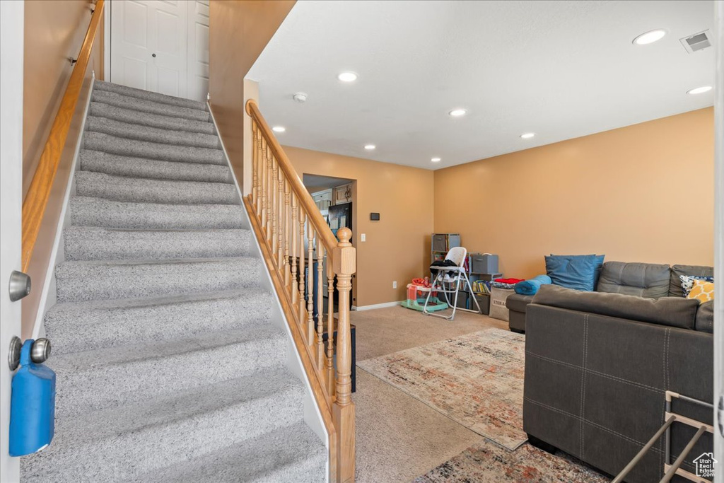 Stairway with baseboards, visible vents, carpet flooring, and recessed lighting