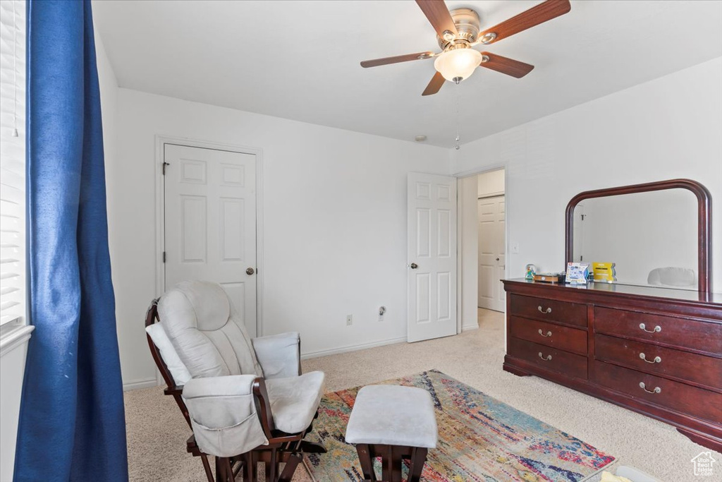 Living area featuring carpet floors and ceiling fan