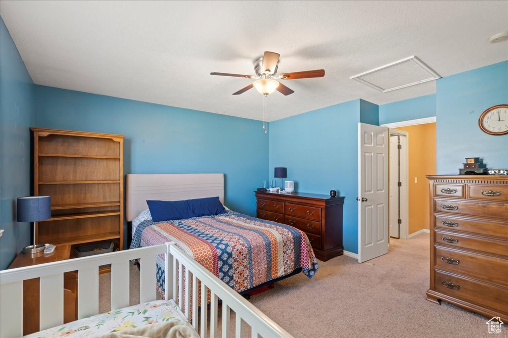 Bedroom featuring attic access, carpet flooring, and ceiling fan