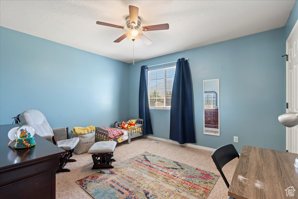 Bedroom featuring carpet floors, baseboards, and a ceiling fan