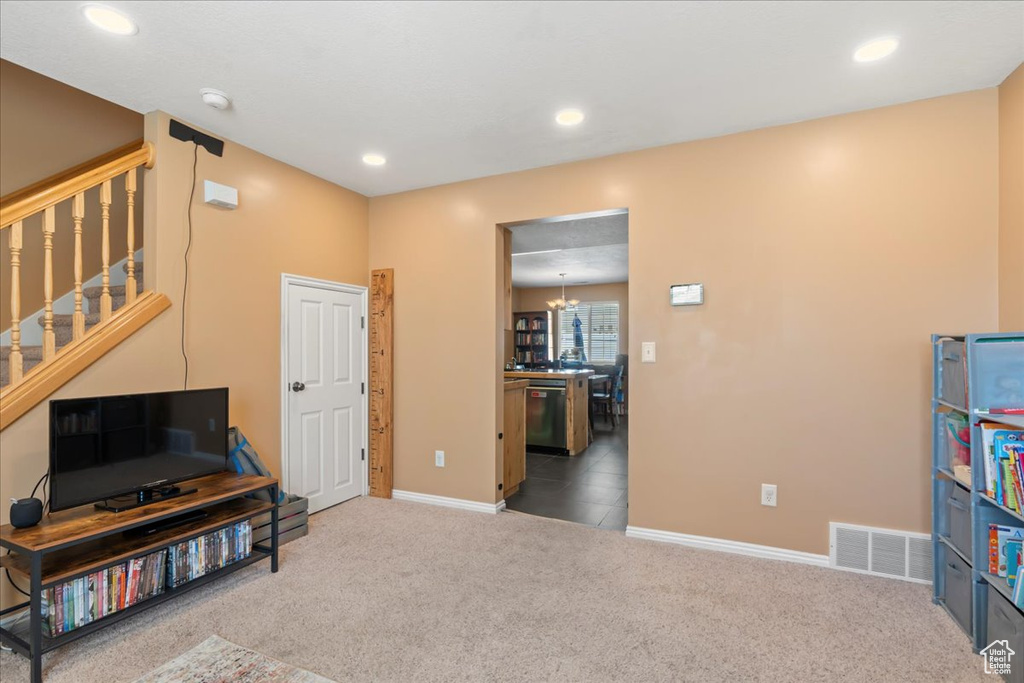 Interior space featuring recessed lighting, visible vents, carpet flooring, a chandelier, and baseboards