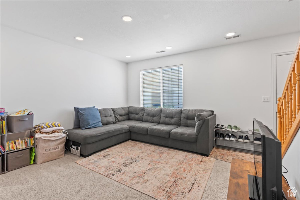 Living area featuring stairs and recessed lighting