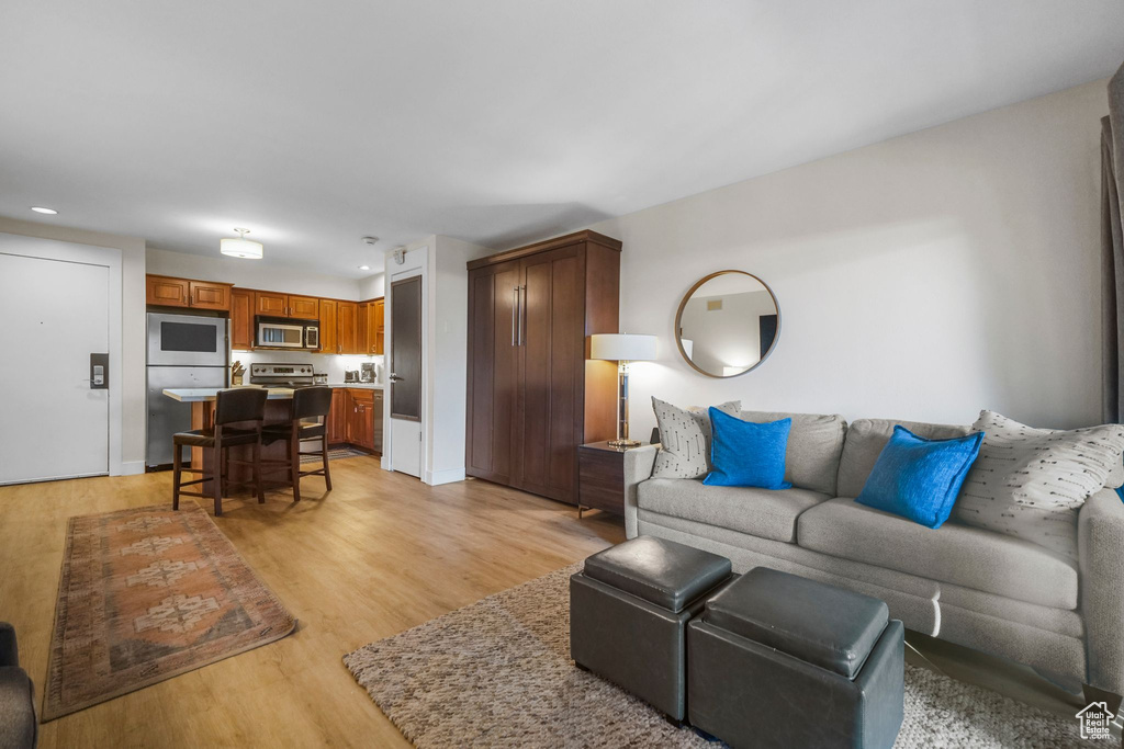 Living room with recessed lighting and light wood-style flooring