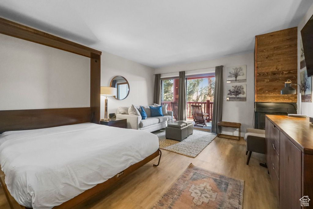 Bedroom featuring light wood-type flooring and access to outside