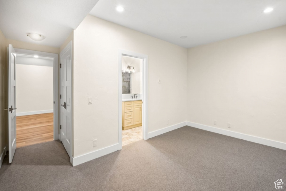 Unfurnished bedroom featuring recessed lighting, baseboards, carpet floors, and connected bathroom