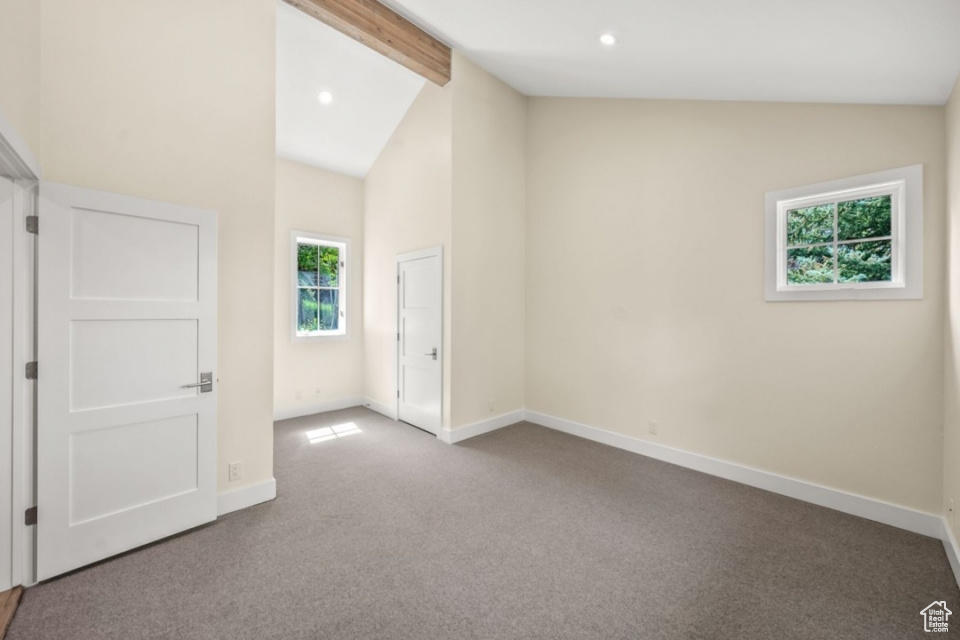 Carpeted spare room with recessed lighting, baseboards, high vaulted ceiling, and beam ceiling