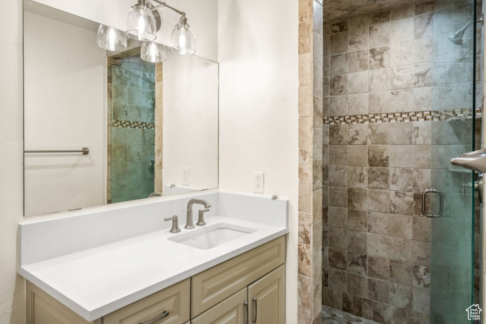 Bathroom with a shower stall and vanity