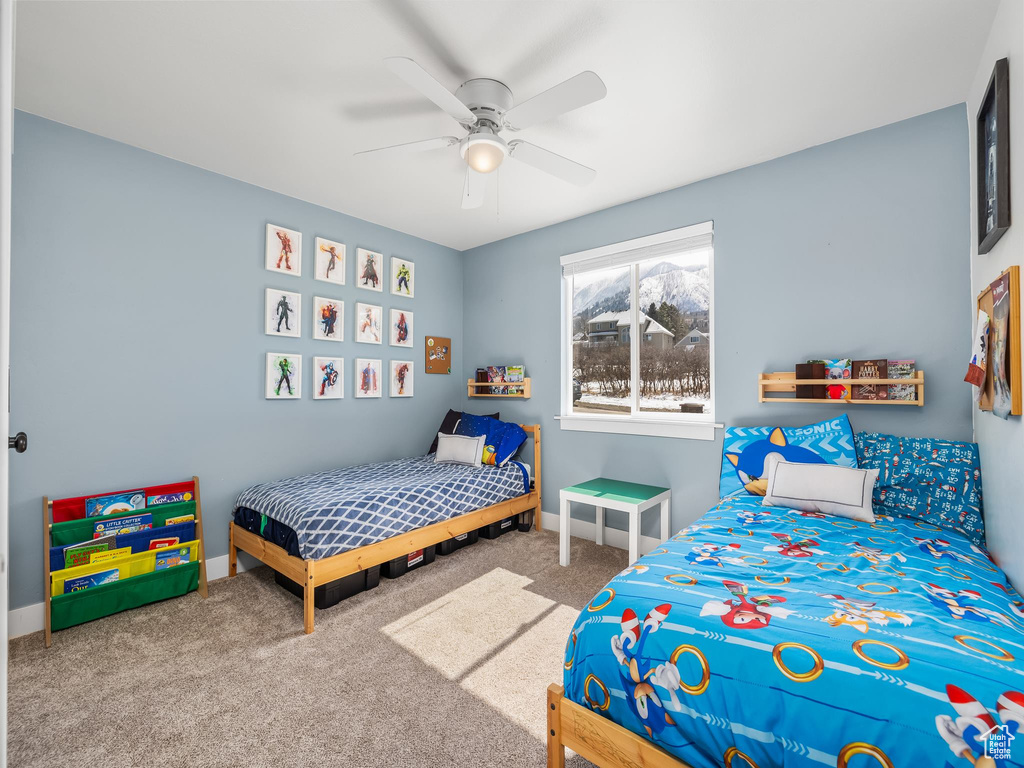 Bedroom with carpet flooring, a ceiling fan, and baseboards