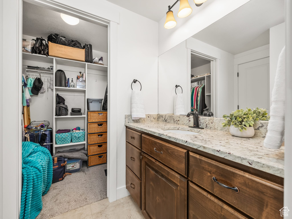 Bathroom featuring vanity and a spacious closet