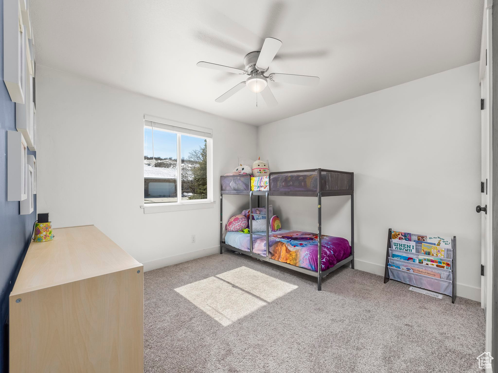 Bedroom with baseboards, a ceiling fan, and carpet flooring