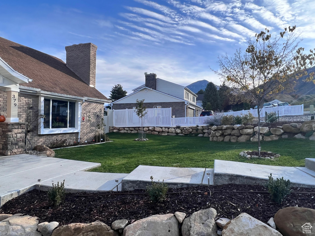 View of yard featuring fence and a mountain view