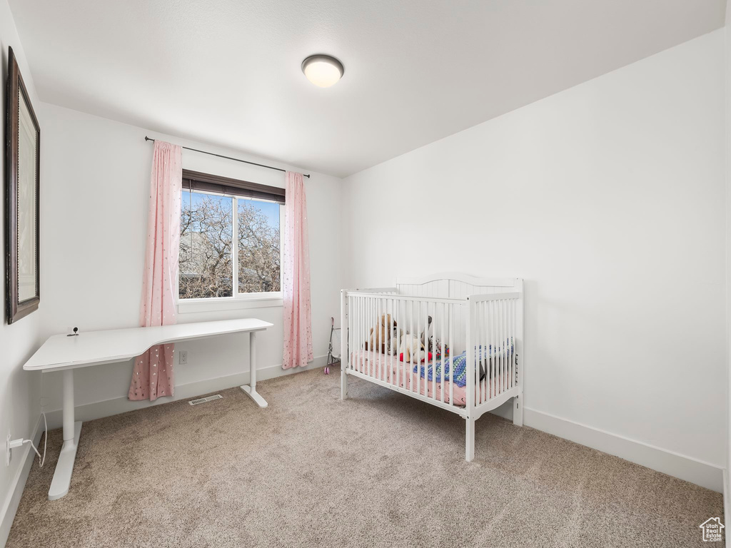 Bedroom with baseboards, carpet floors, and visible vents