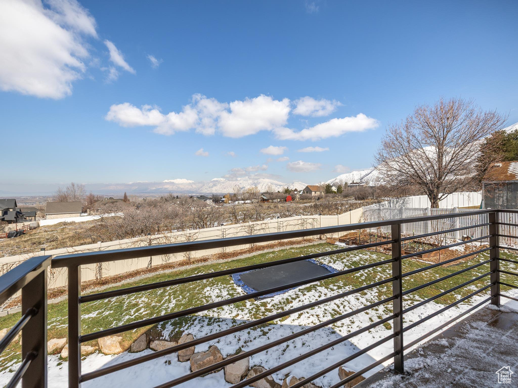 Snow covered back of property featuring a mountain view