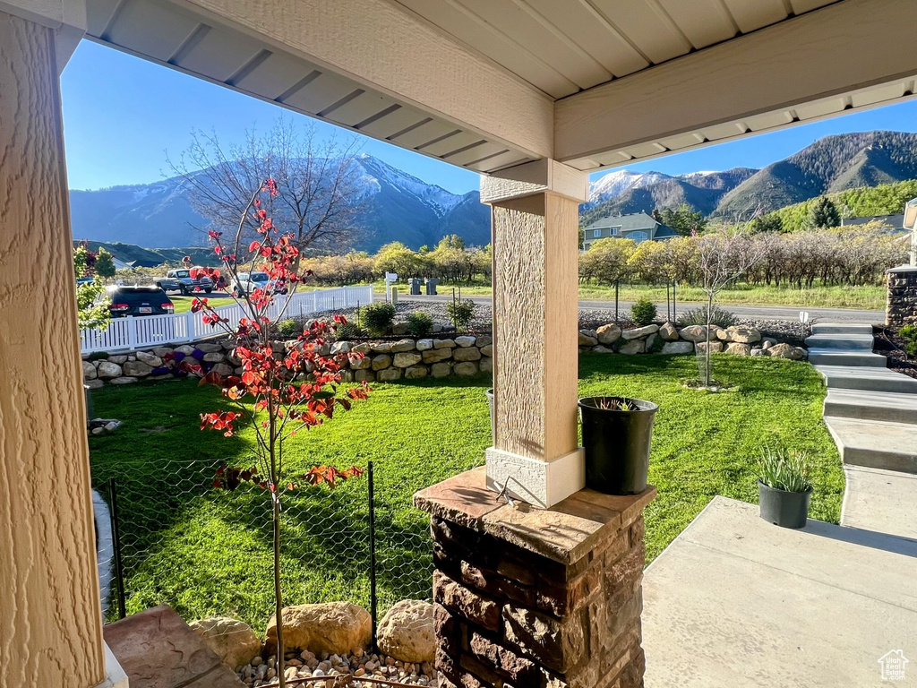 View of patio / terrace with fence and a mountain view