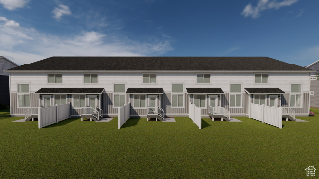 Rear view of property with a shingled roof, a lawn, a wooden deck, and a sunroom