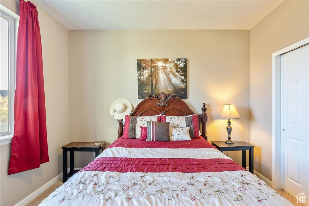 Carpeted bedroom with baseboards