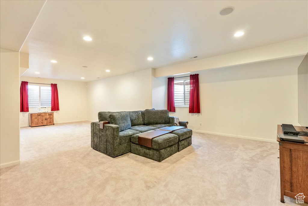 Living area with light carpet, recessed lighting, baseboards, and healthy amount of natural light