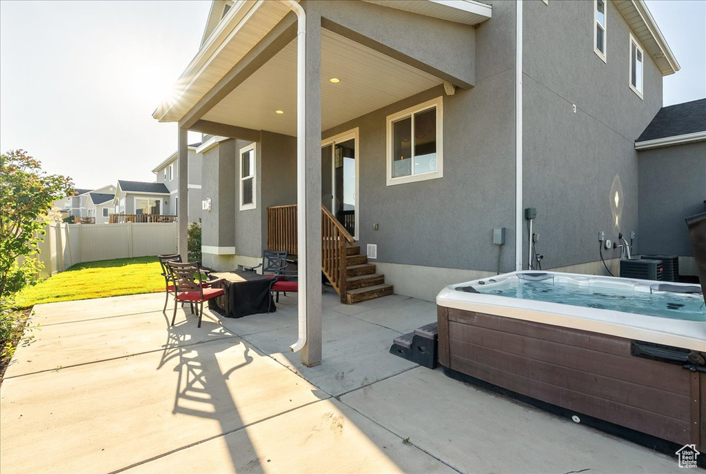 View of patio featuring a hot tub and central AC unit