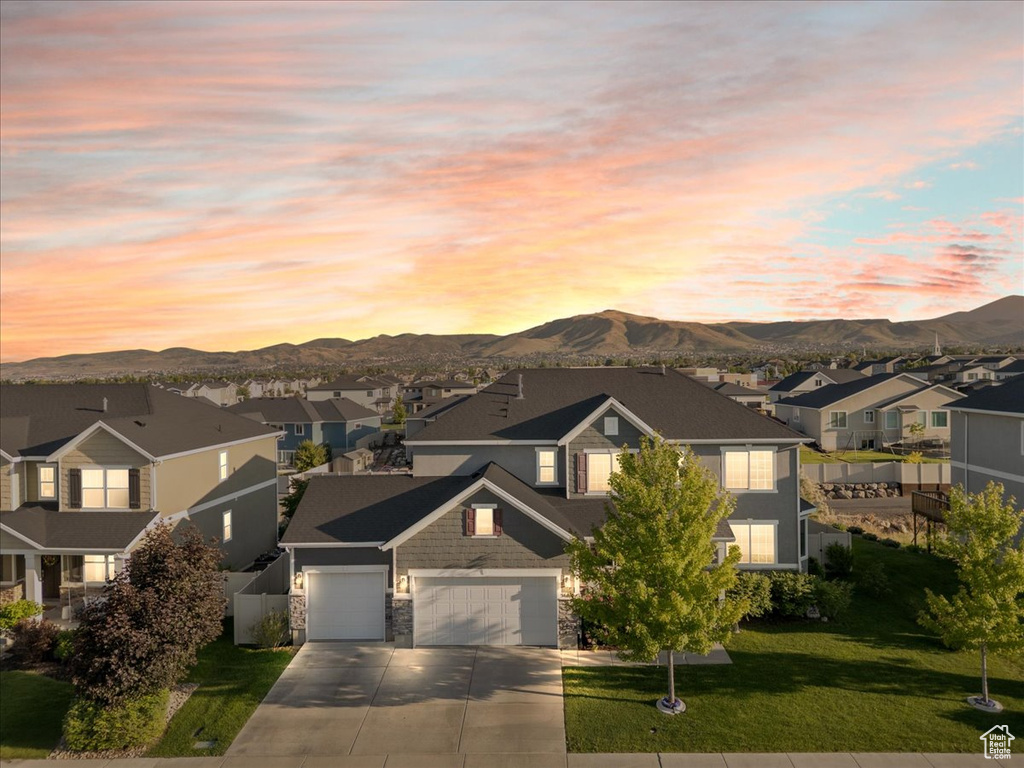 Traditional home with a residential view, driveway, and a mountain view