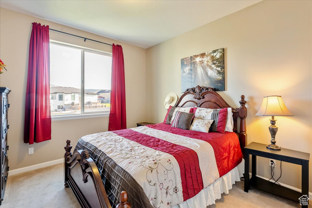 Bedroom with light carpet and baseboards
