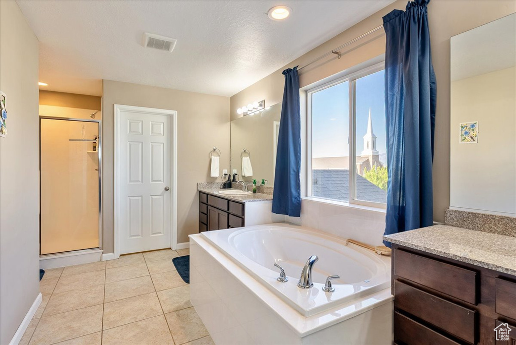 Bathroom with vanity, a bath, a shower stall, baseboards, and recessed lighting
