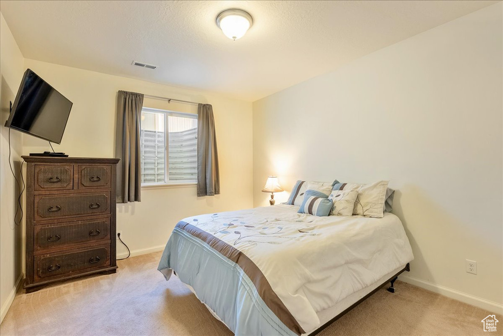Carpeted bedroom featuring baseboards