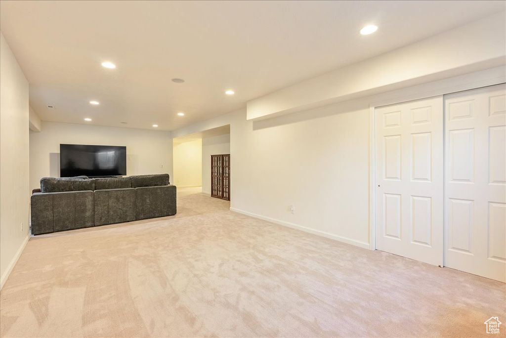 Unfurnished living room with carpet, recessed lighting, and baseboards