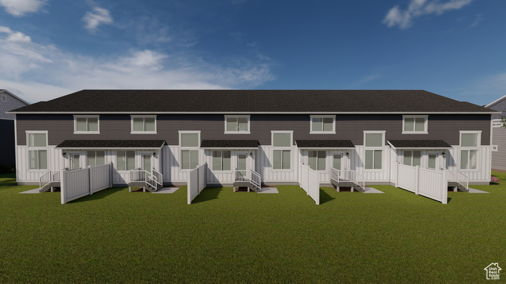 Back of property featuring a wooden deck and a yard