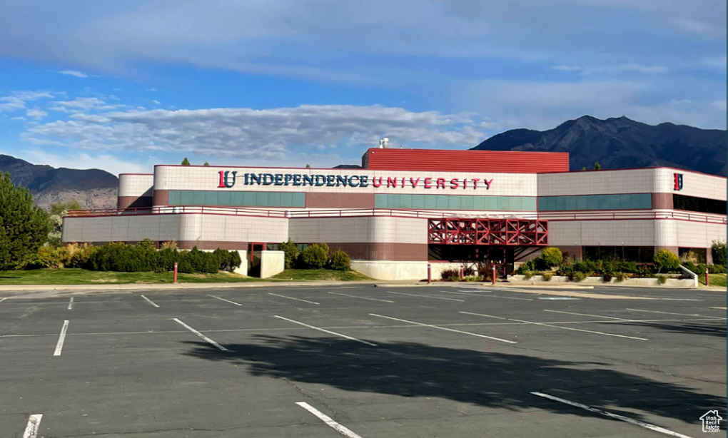 View of property featuring a mountain view and uncovered parking