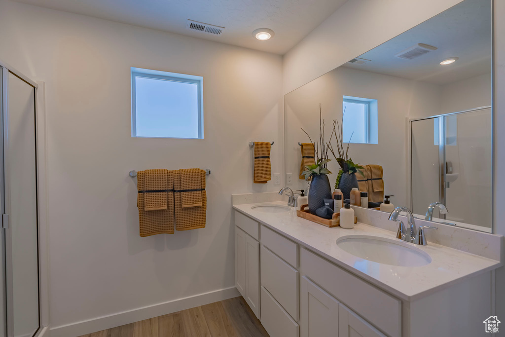 Full bath featuring a stall shower, visible vents, and a sink