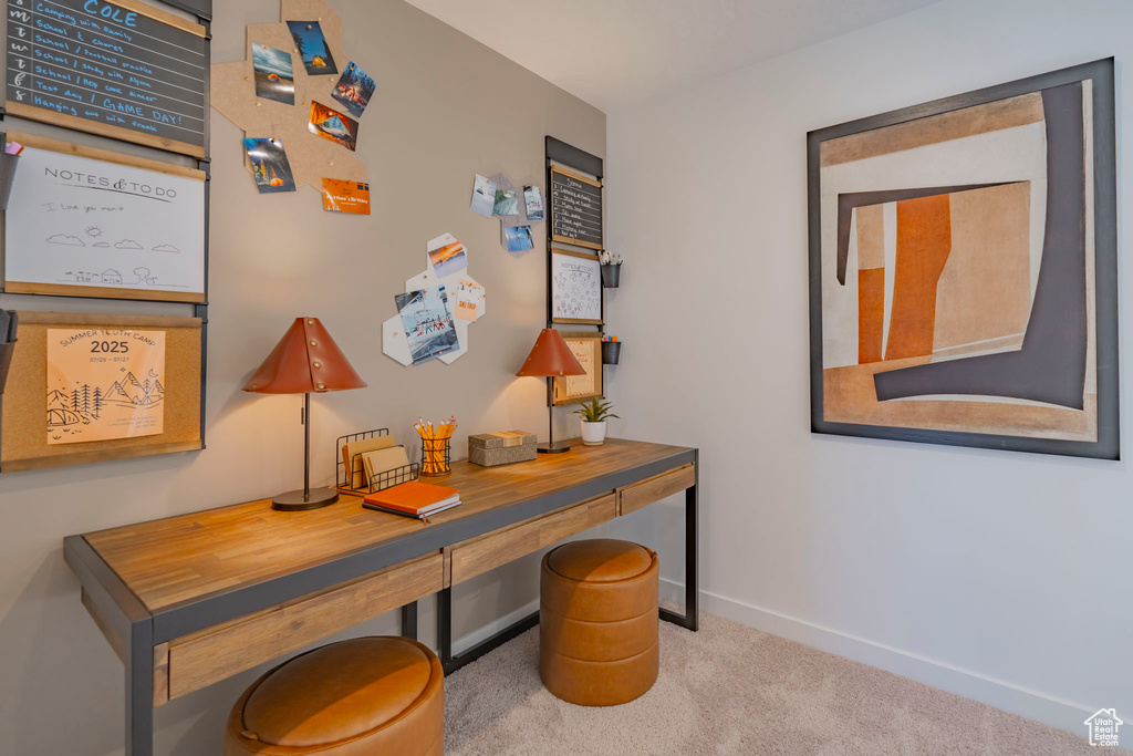 Home office featuring carpet flooring and baseboards