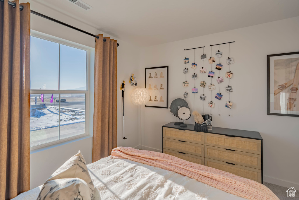 Bedroom with visible vents and baseboards