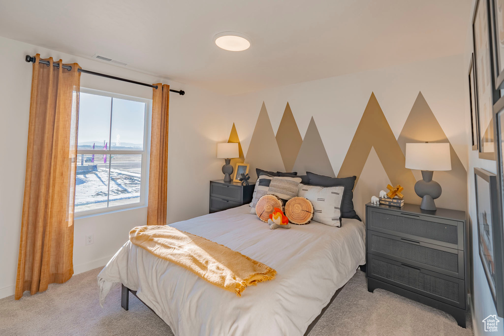Bedroom featuring carpet flooring, visible vents, and baseboards