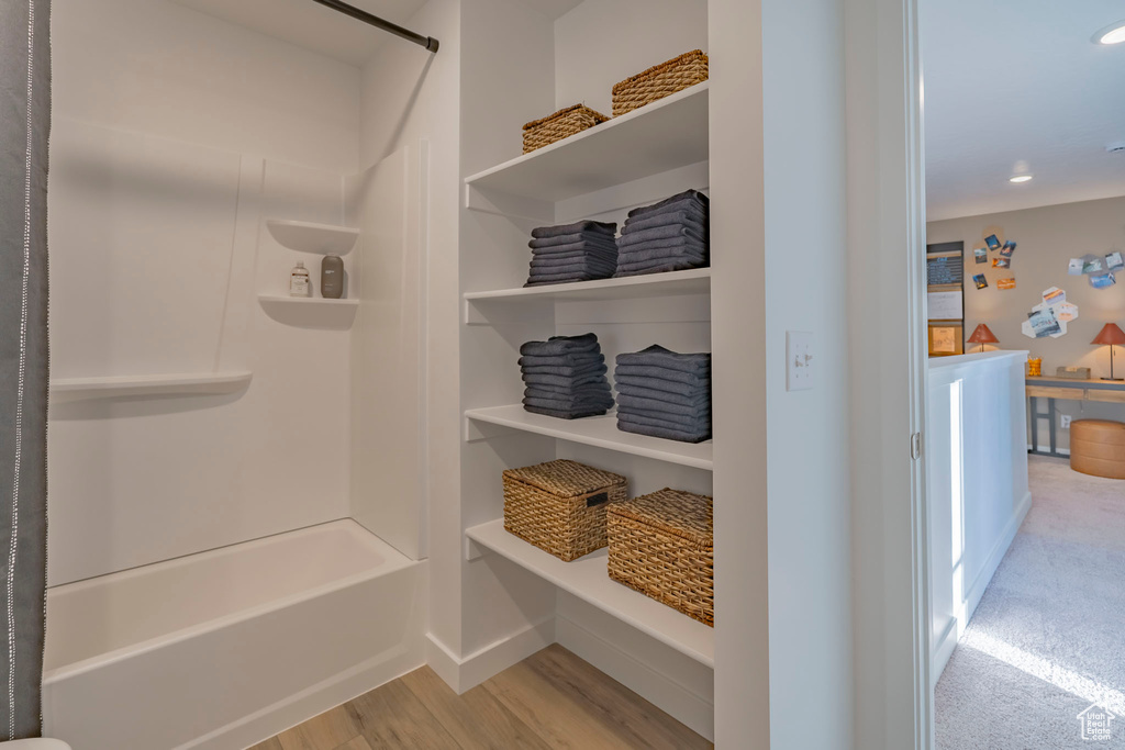 Interior space with recessed lighting, wood finished floors, and baseboards