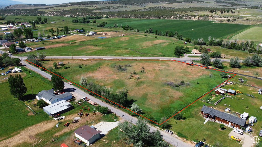Aerial view of sparsely populated area featuring property boundaries highlighted and mountains
