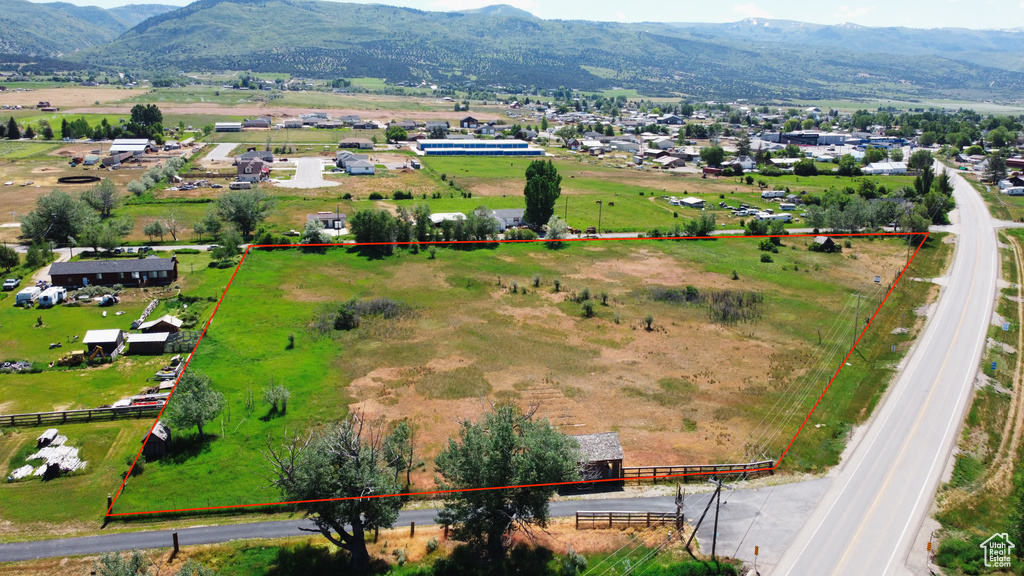 View of rural area with property boundaries highlighted and a mountain backdrop