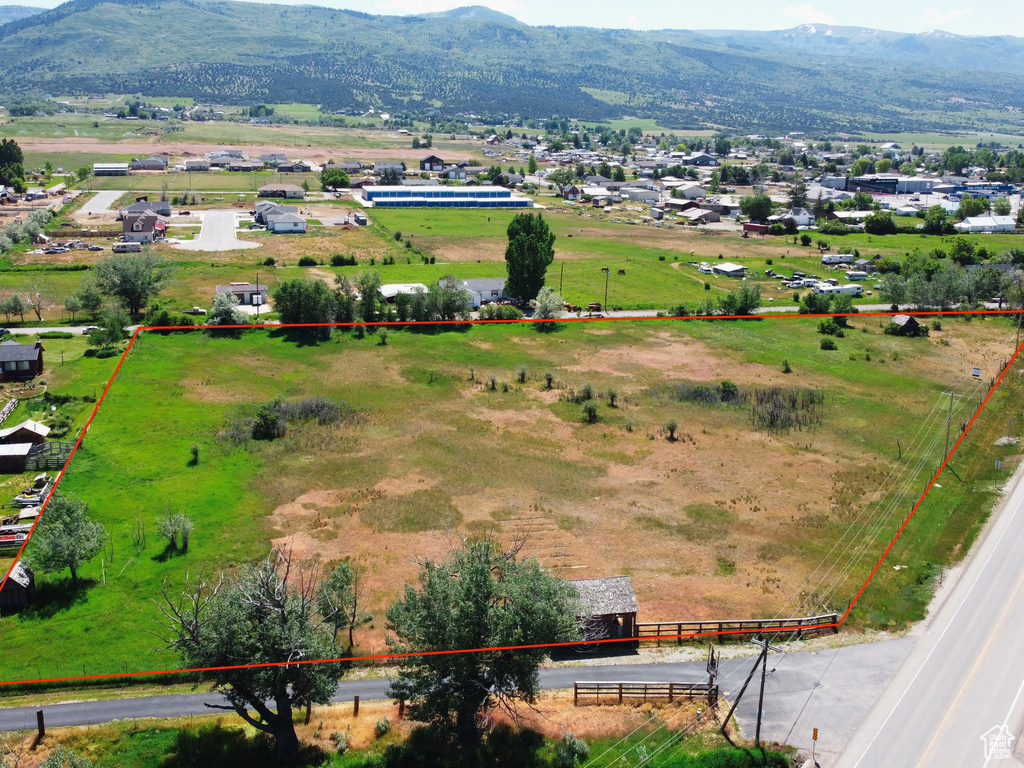 View of rural area with property boundaries highlighted and a mountain backdrop