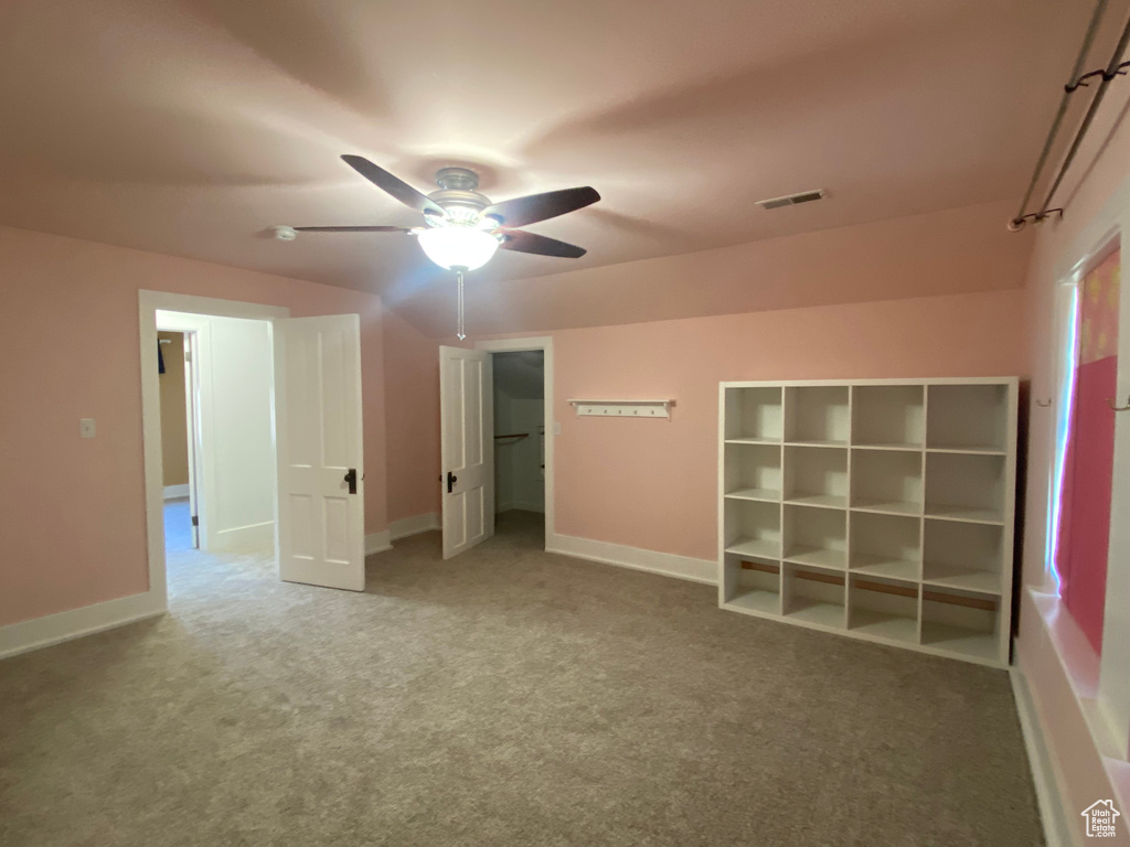 Unfurnished bedroom featuring a ceiling fan, carpet, visible vents, and baseboards